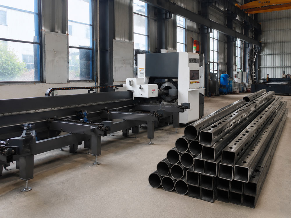 Laser tube cutting machine processing steel tubes in a modern fabrication workshop
